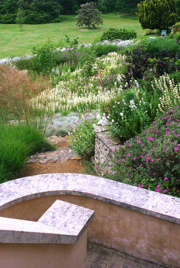 View down into the garden from stone steps. Rae Wilkinson Garden and Landscape Design Surrey, Sussex, Hampshire, London, South-East England
