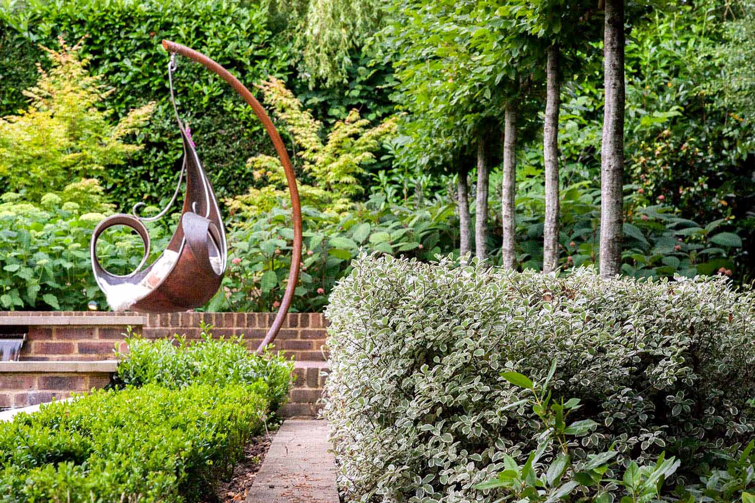 View of classic, modern garden design. Rae Wilkinson Garden and Landscape Design Surrey, Sussex, Hampshire, London, South-East England