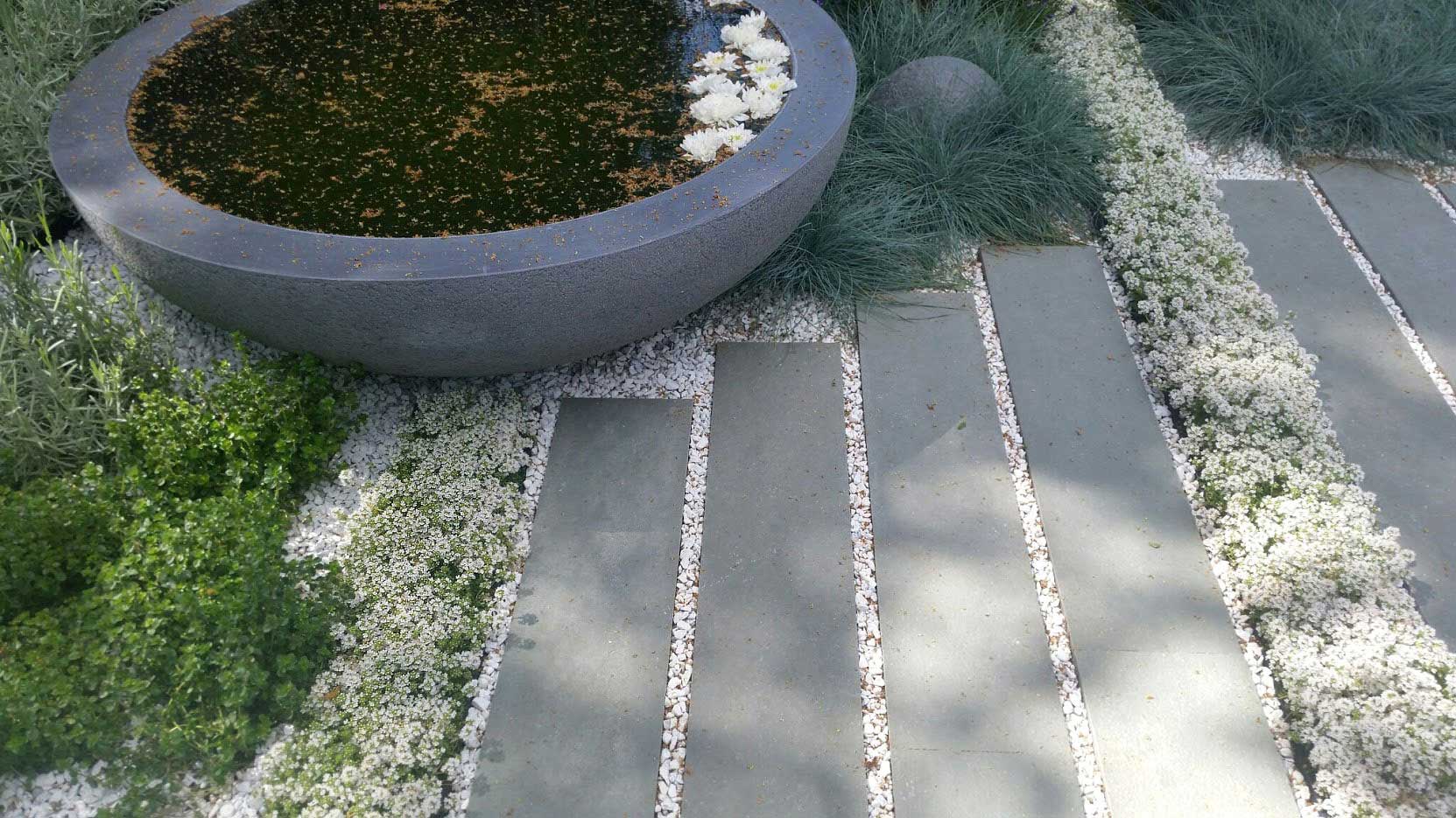 Detail of planter and paving in Rae Wilkinson's RHS Hampton Court Show Garden. Rae Wilkinson Garden and Landscape Design Surrey, Sussex, Hampshire, London, South-East England